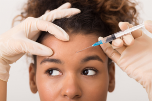 woman getting botox injections in forehead